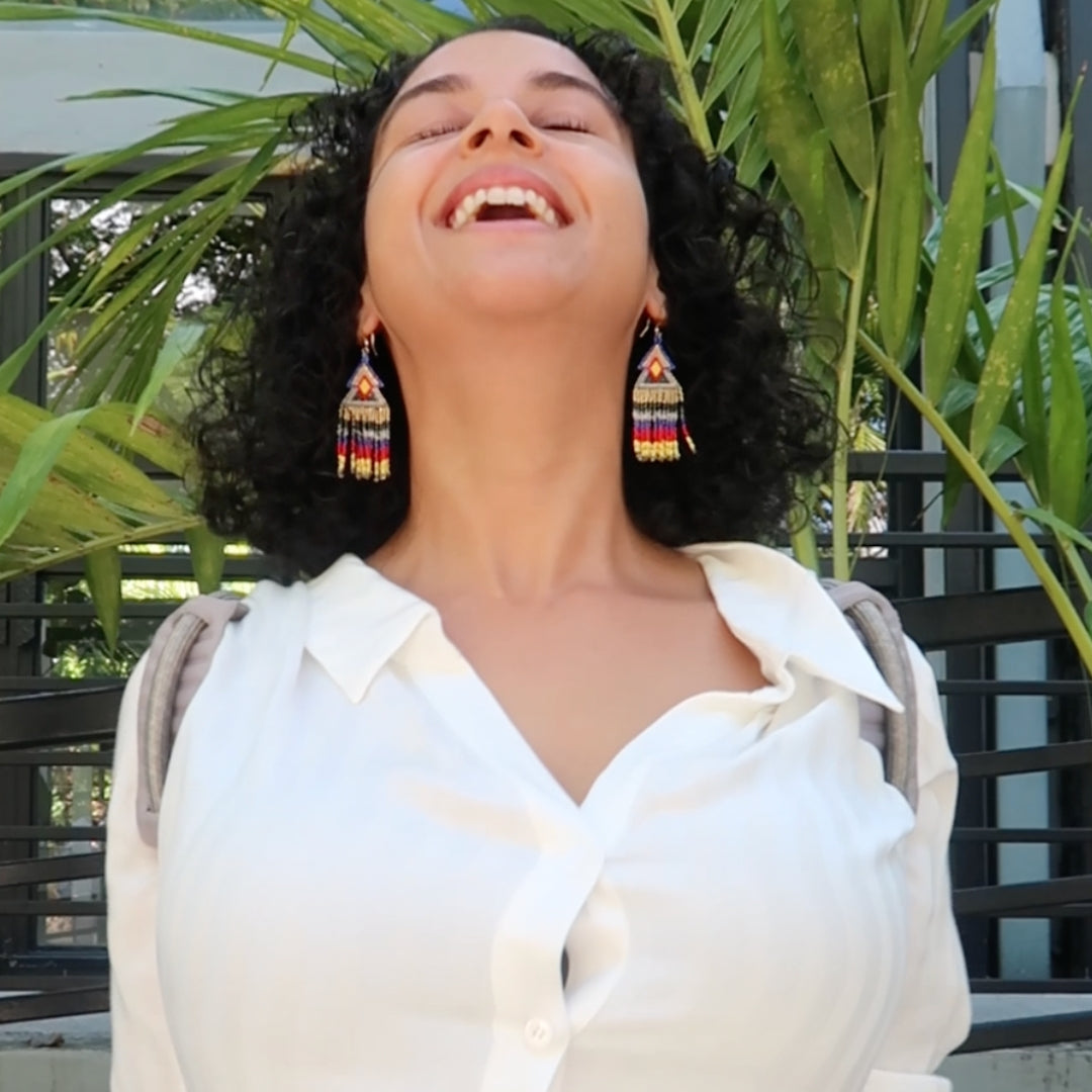 A cheerful employee beaming with satisfaction while wearing The Back Transformer back brace during a break in the office.